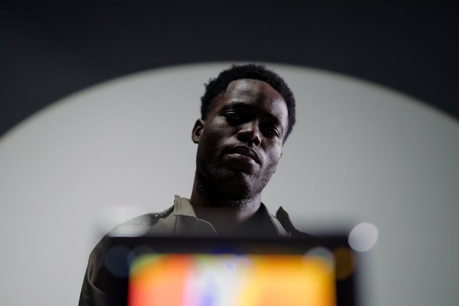 Low Angle Shot of a Man Standing Behind an Infrared Camera