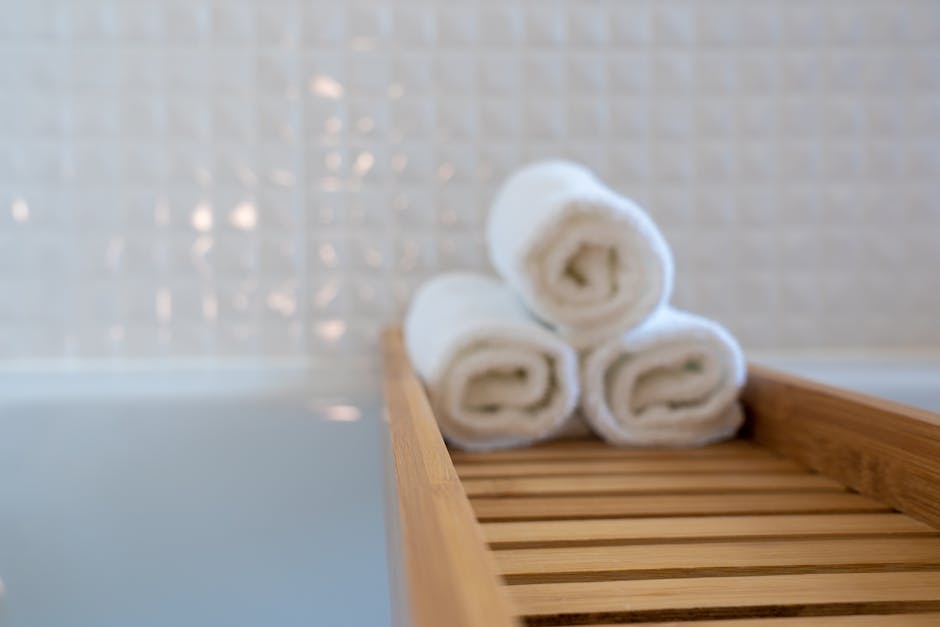 Three Towels on Brown Wooden Rack