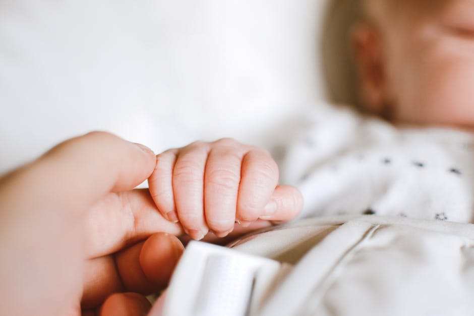 Person Holding Baby’s Hand