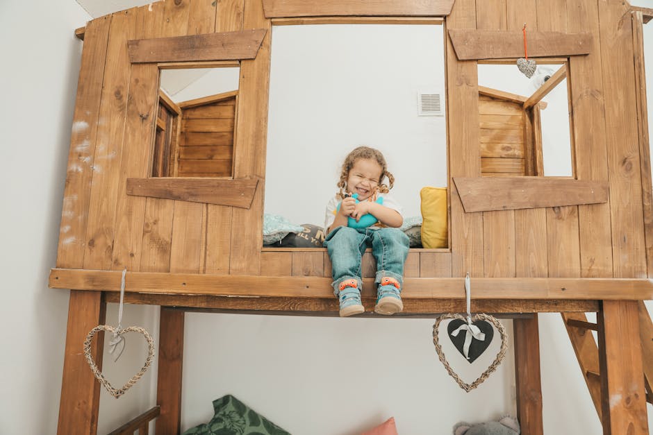 A child sitting on a wooden bunk bed