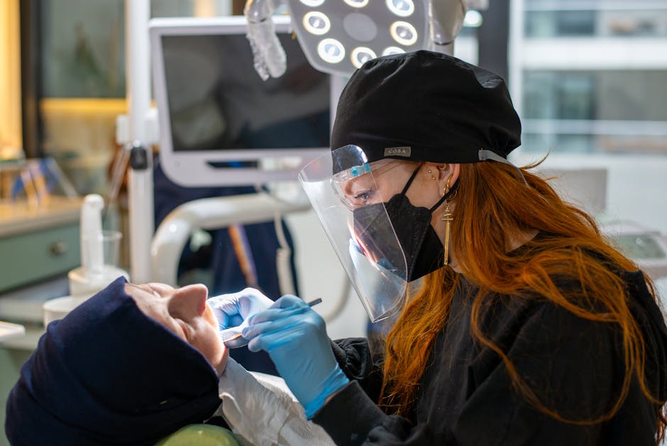 A Dentist Examining a Patient at a Dental Clinic