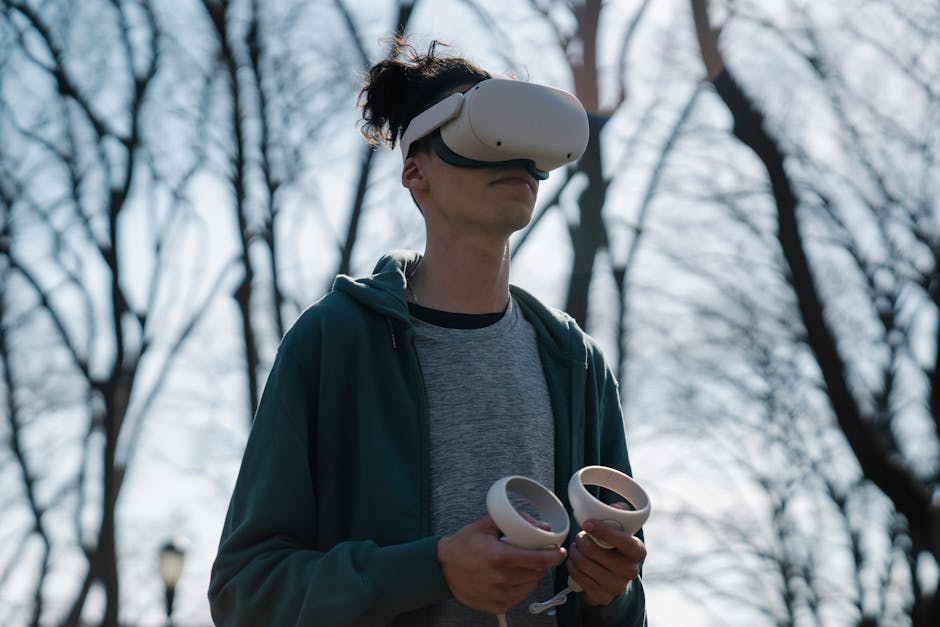 Anonymous male in virtual reality headset enjoying game on blurred background of leafless trees