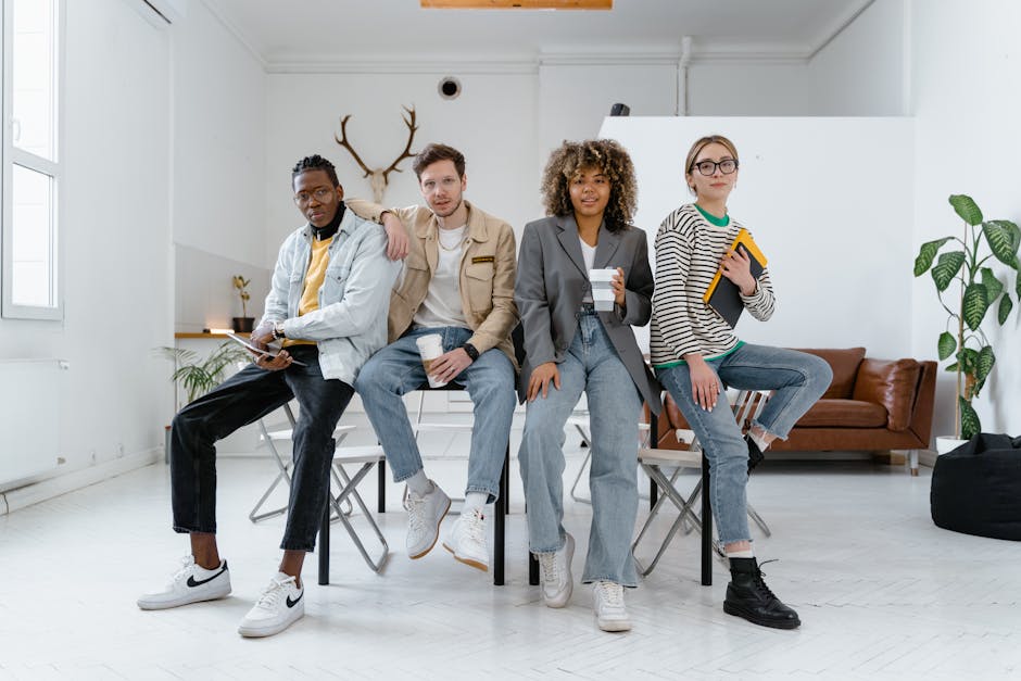 3 Women and 2 Men Sitting on Blue Couch