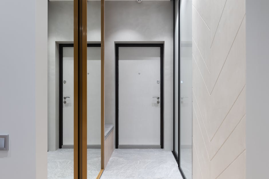 Modern hallway with mirror walls and white door