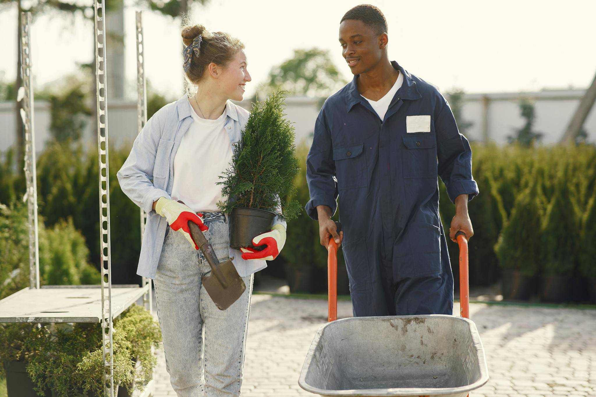 Maintenance Man walking alongside a Gardener