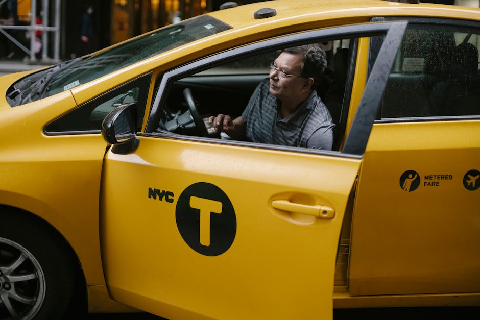 Taxi driver getting out of yellow cab