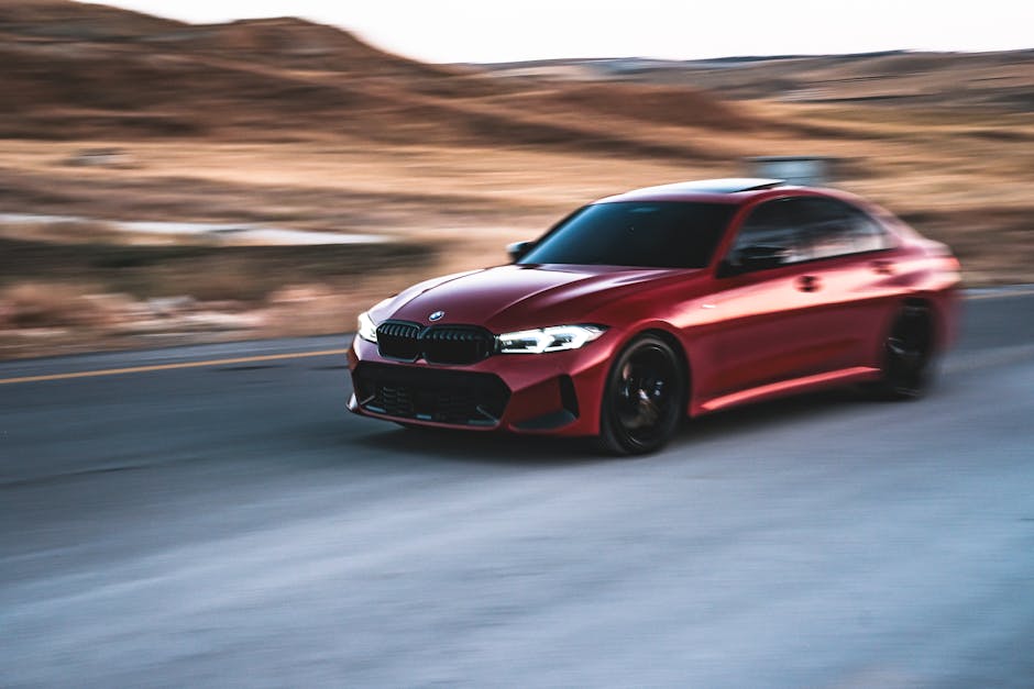 The red bmw m5 is driving down a road