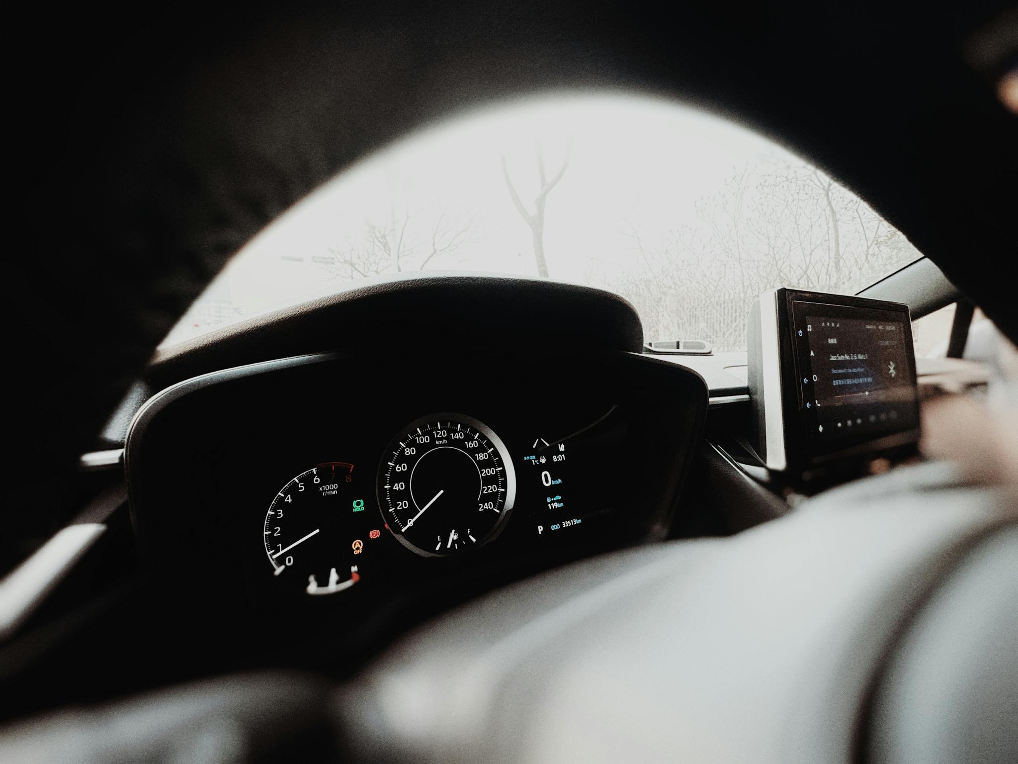A dashboard view of a car with a dashboard