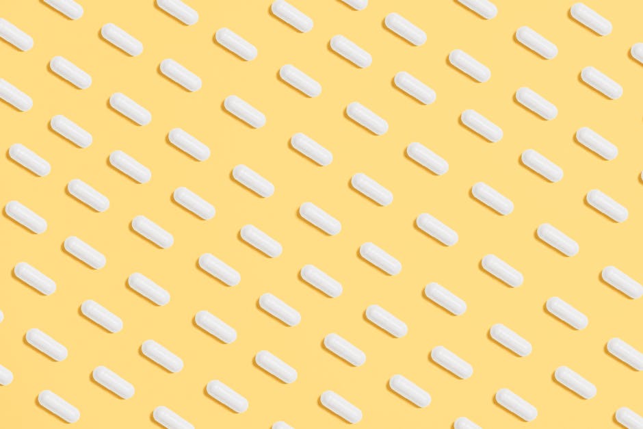 White Capsules on Yellow Background