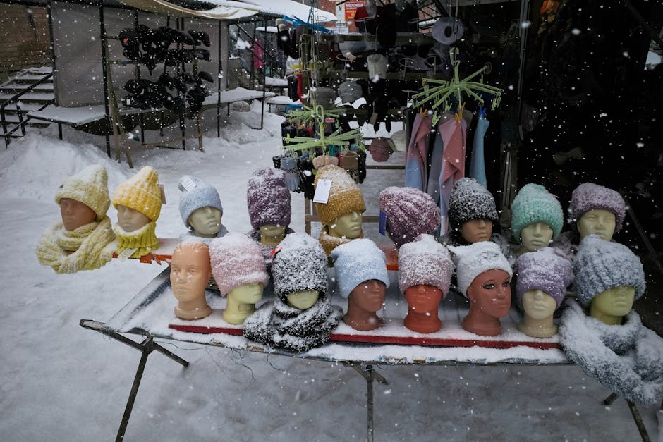 Beanies and Winter Clothing on Display on a Snowy Day