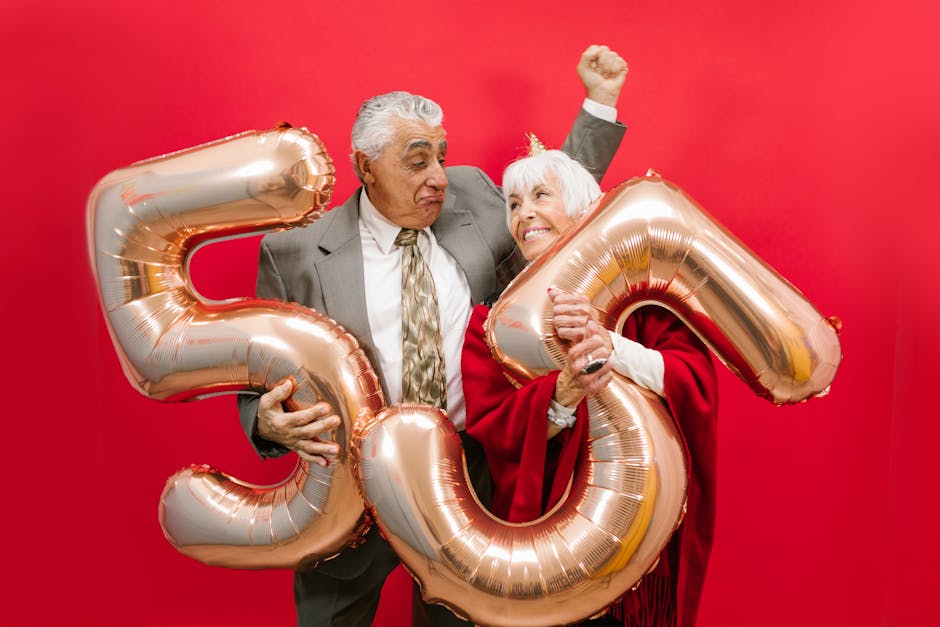 A Couple Holding Number Balloons With Red Background