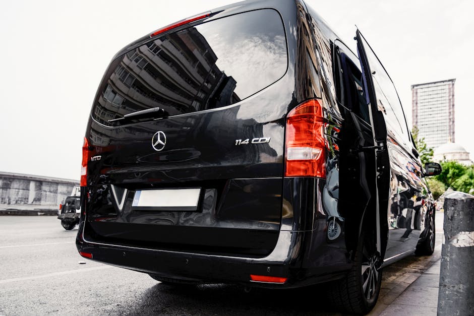 A black mercedes van parked on the side of a street