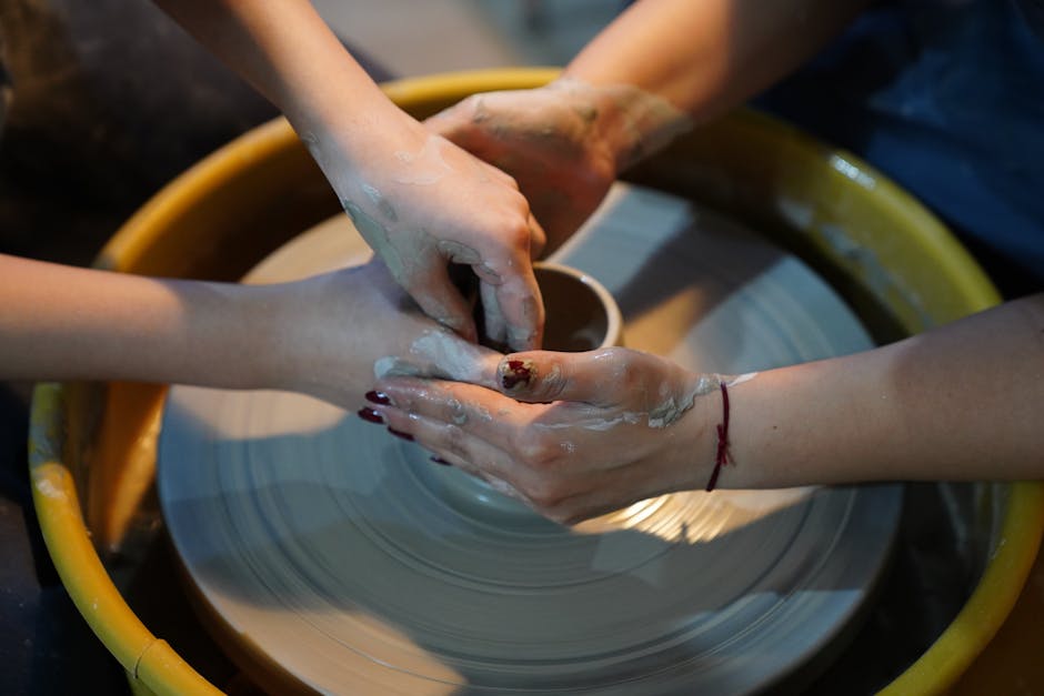 Two hands are making a pottery wheel