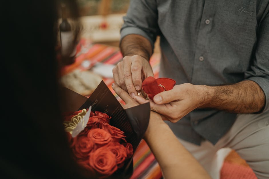 A man is putting a red rose into a woman’s hand