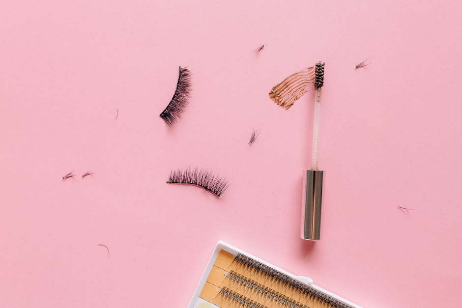 Eyelashes and Mascara Brush on a Pink Surface