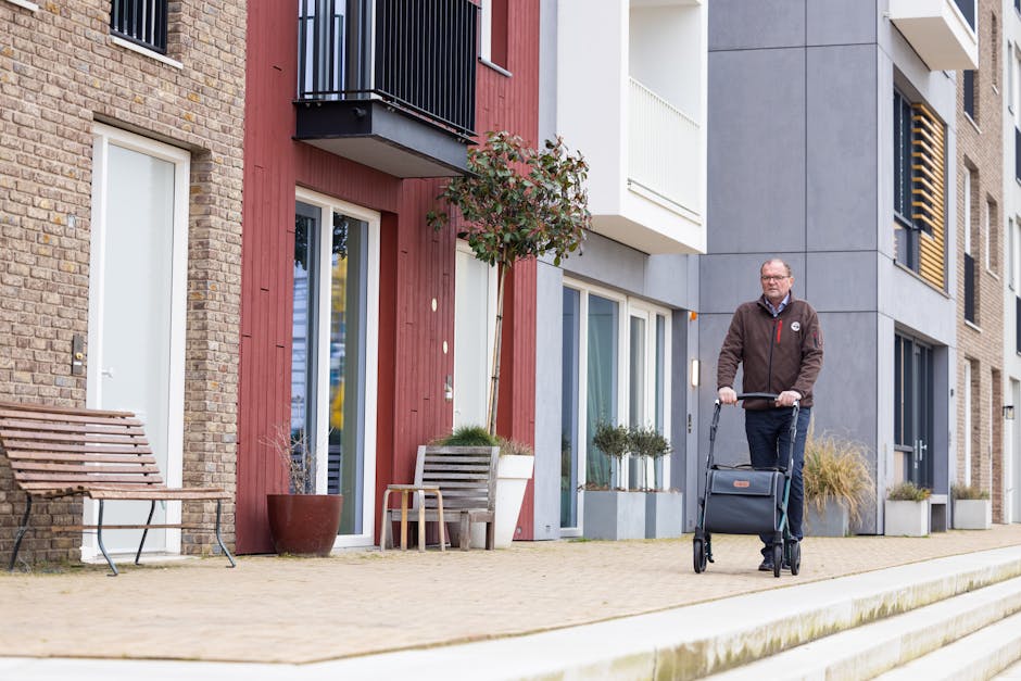 man with walker on sidewalk in front of apartments