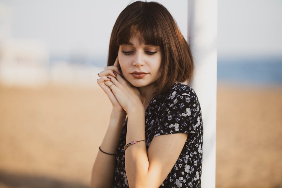 Woman Leaning on White Metal Pole