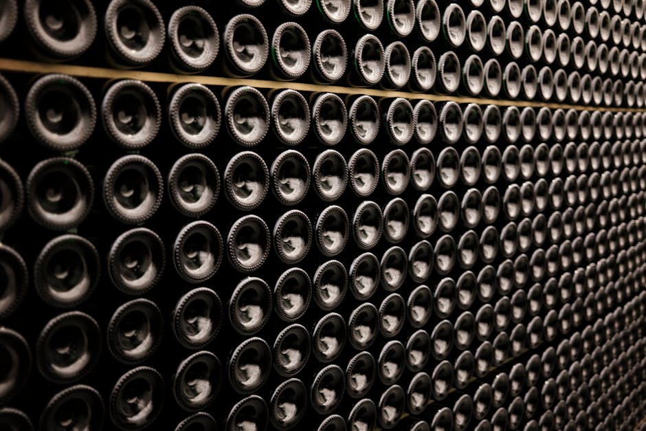 Close-up of Wine Bottles Lying in Rows in a Wine Cellar