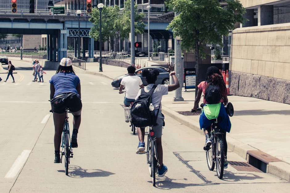 People Riding Bicycles on Road