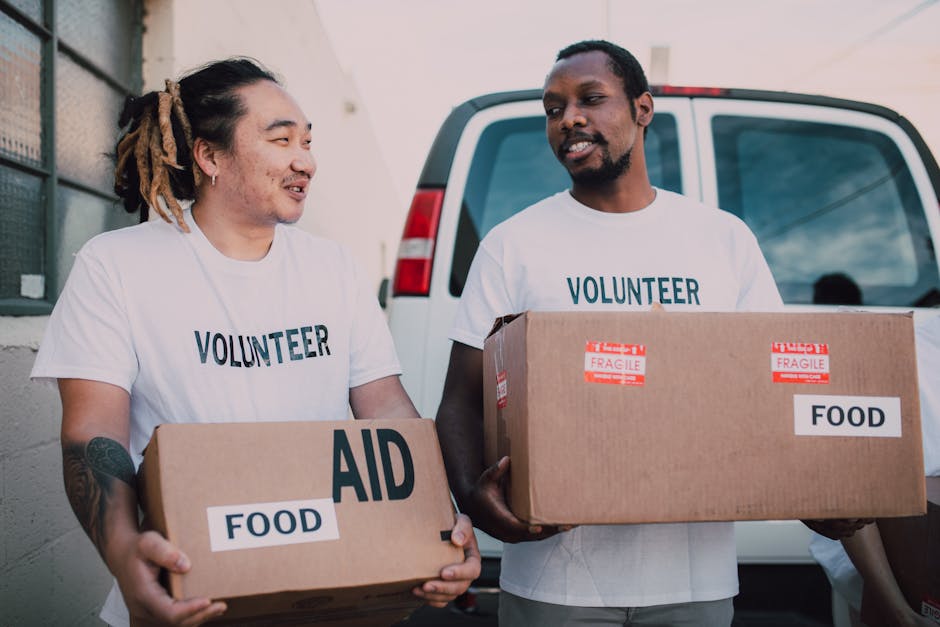 Men Volunteers Carrying Boxes  with Relief Goods