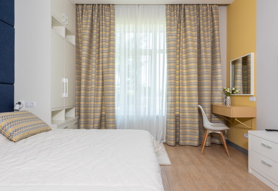 Comfortable bedroom designed with striped curtains white cabinets large bed and decorative pillow