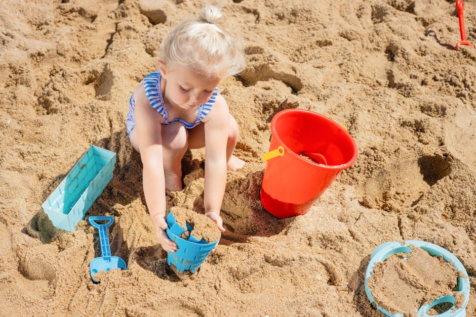 A Young Girl Playing on the Beach Sand