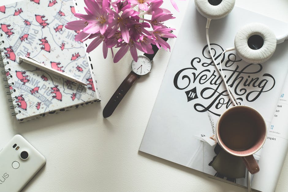 Flat Lay Photography of Cup, Watch, Notebook, and Headphones