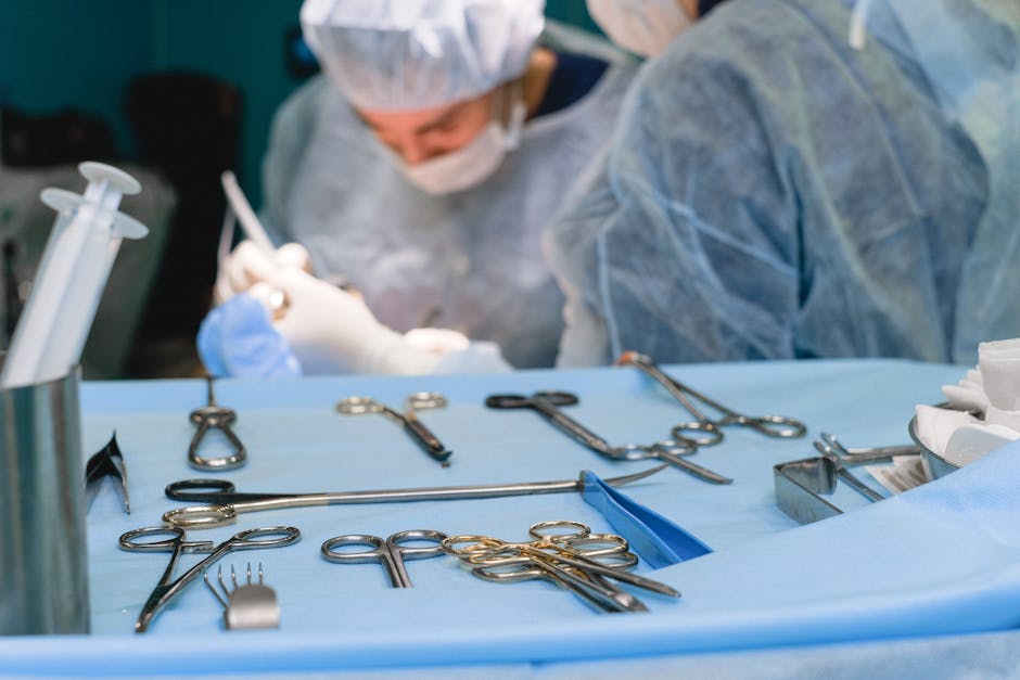 Medical Instruments and Surgeon Performing a Surgery