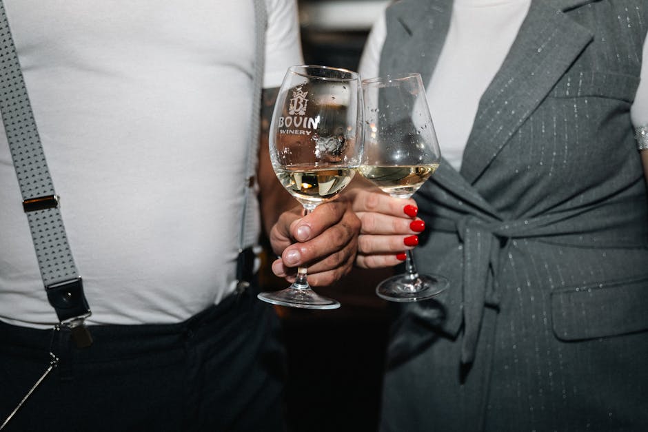 Two people holding wine glasses together