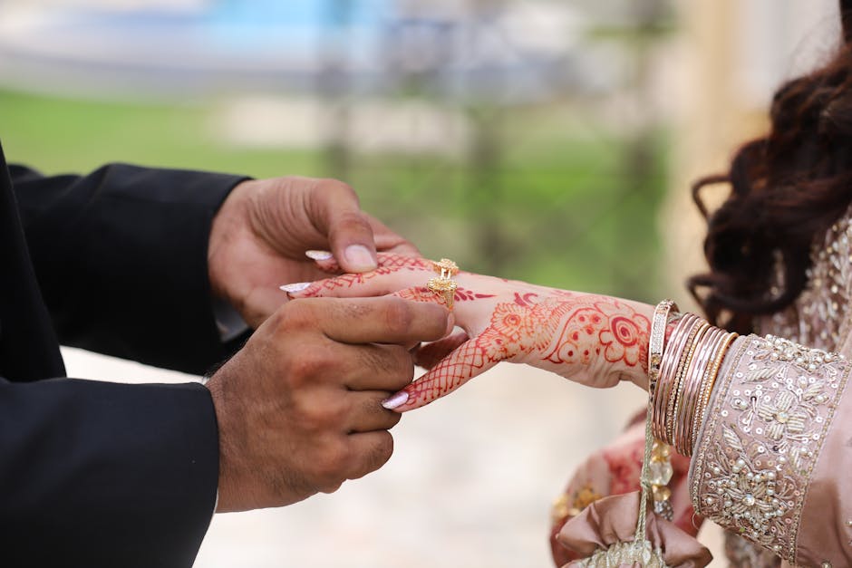 A man putting a ring on a woman’s hand