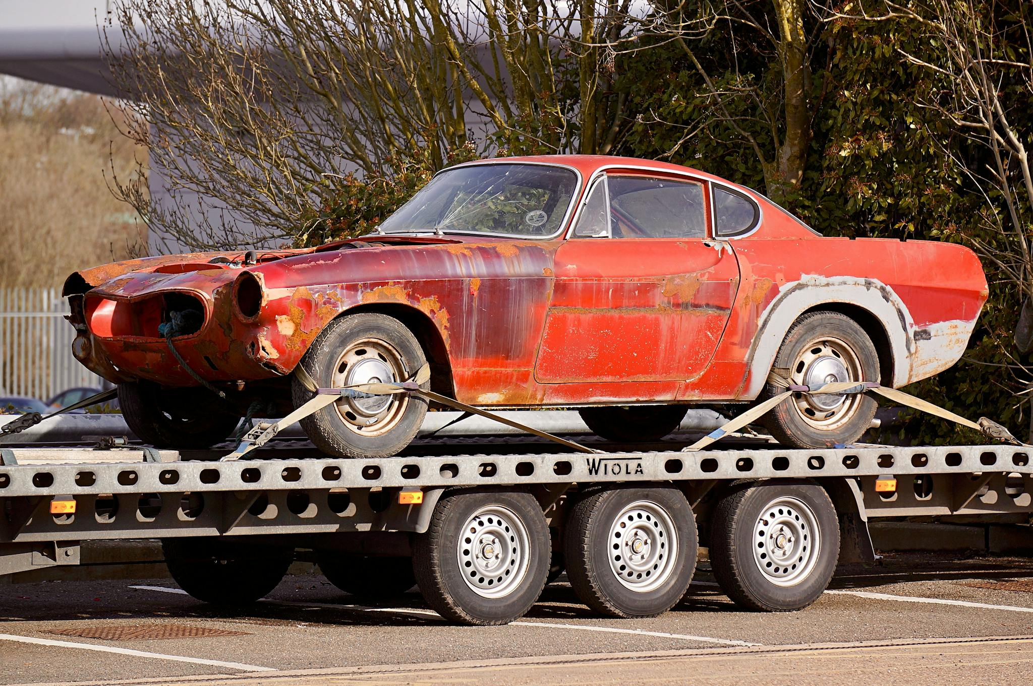 Red Coupe on Flatbed Trailer