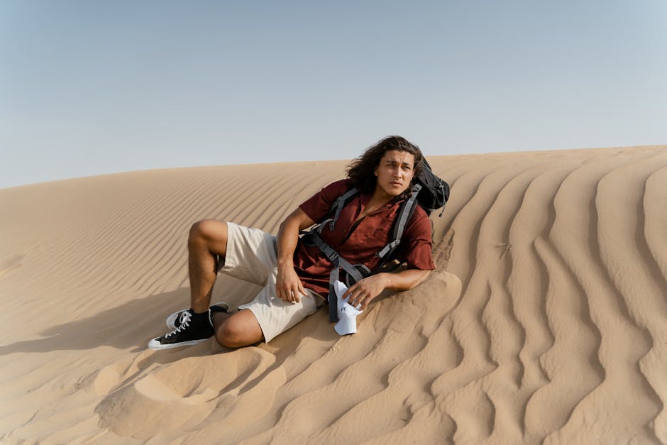 Man in Red Polo Lying on Sand