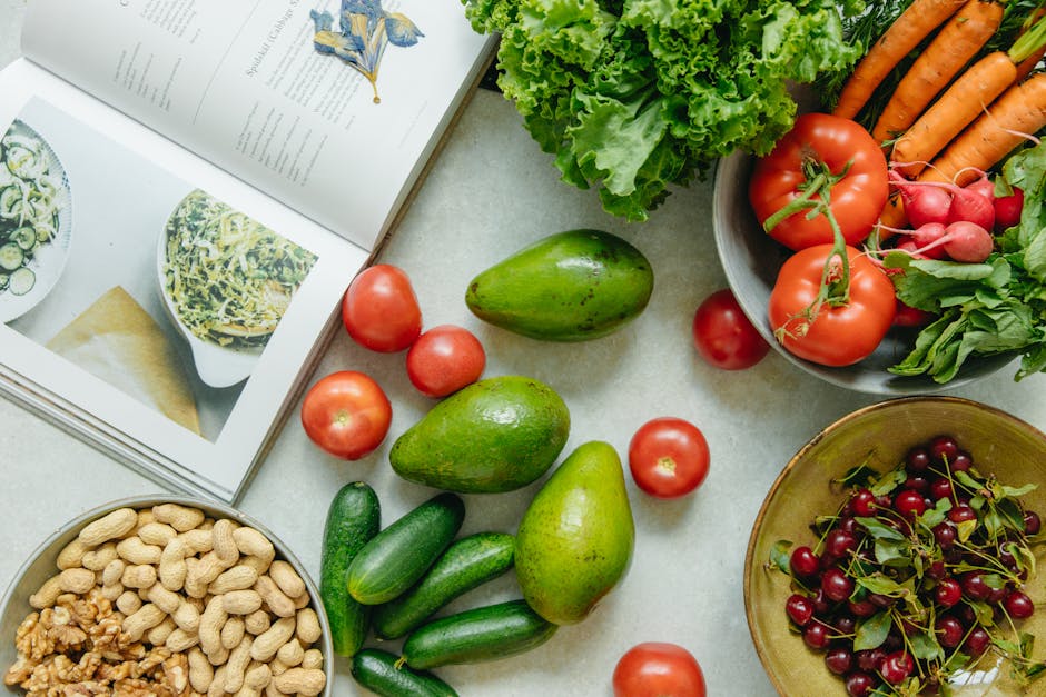 Top View of a Cookbook and Variety of Healthy Foods on a Table