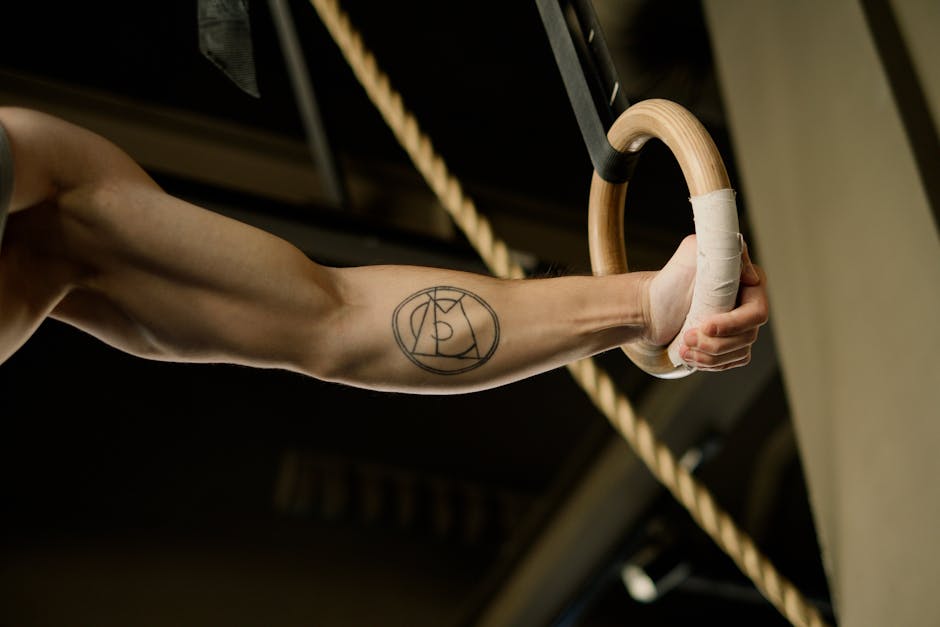 Person Holding Gymnastic Rings