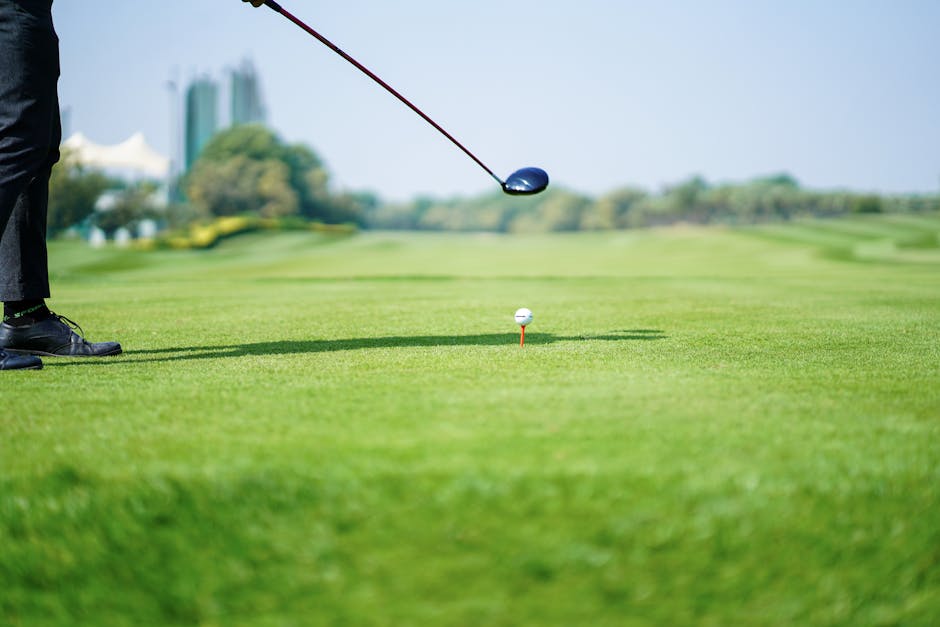 Anonymous golf player preparing to hit ball