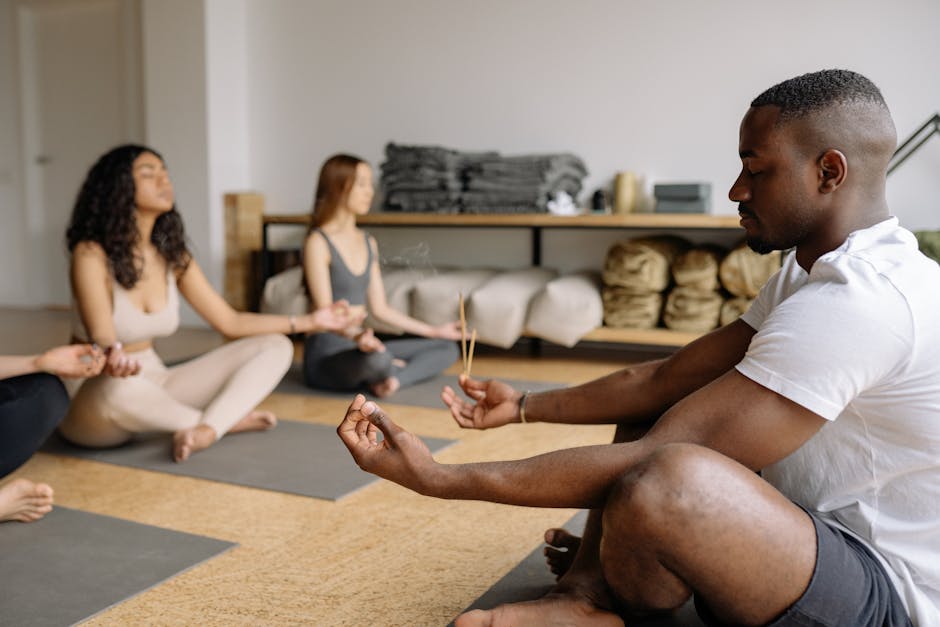 Yoga Teacher Meditating with Group