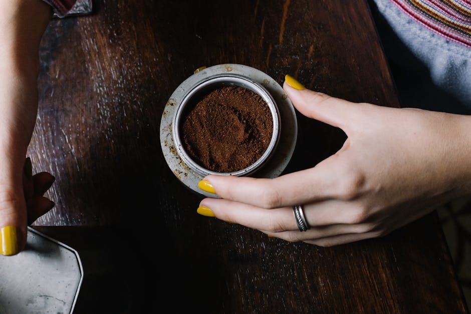 Woman Holding a Bowl of Ground Coffee Powder