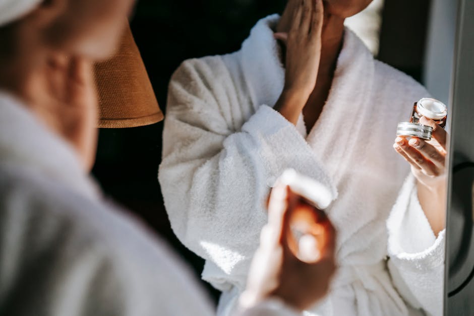 Black woman applying cream in  bathroom