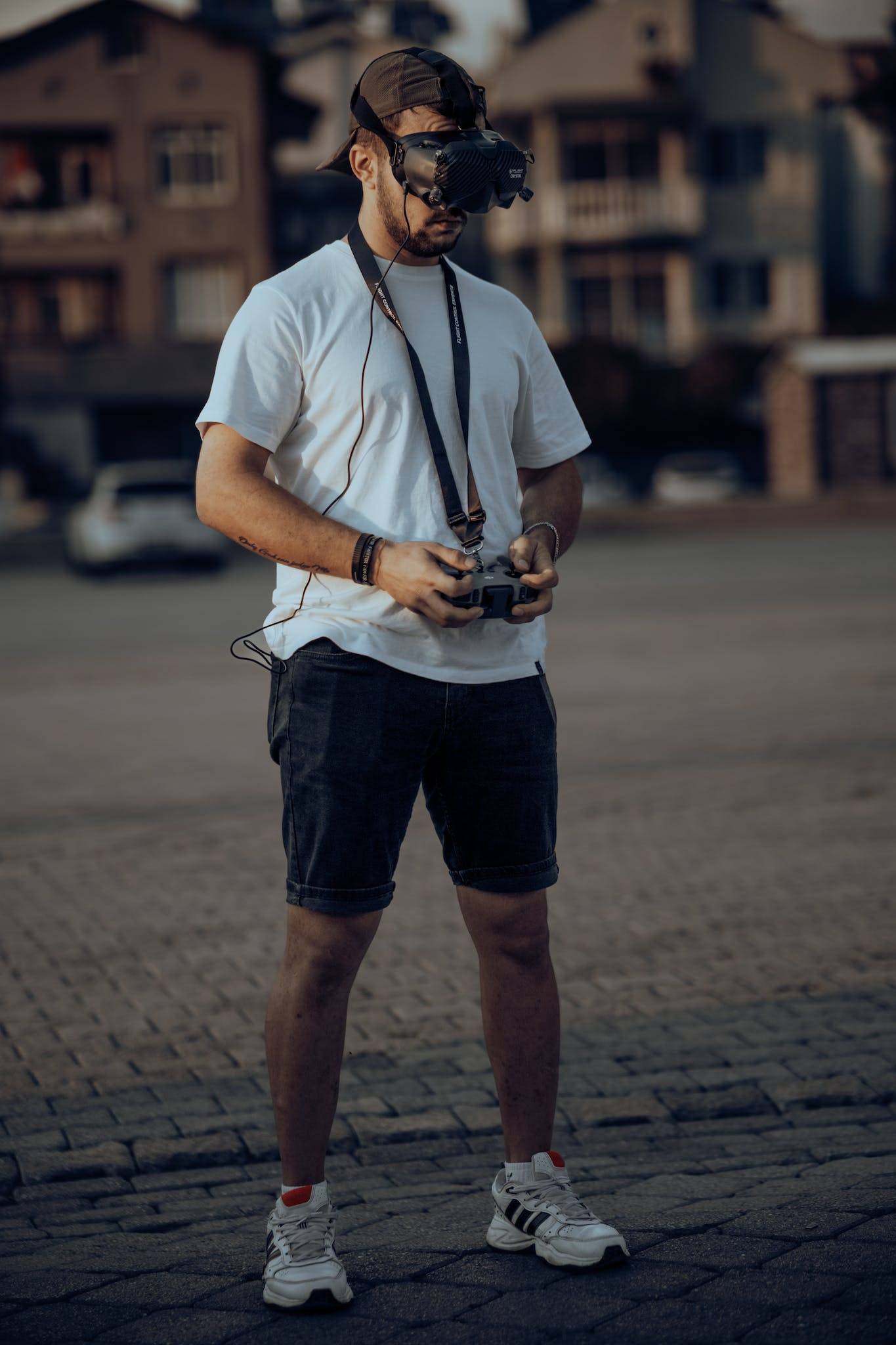 A man with a camera and a white shirt