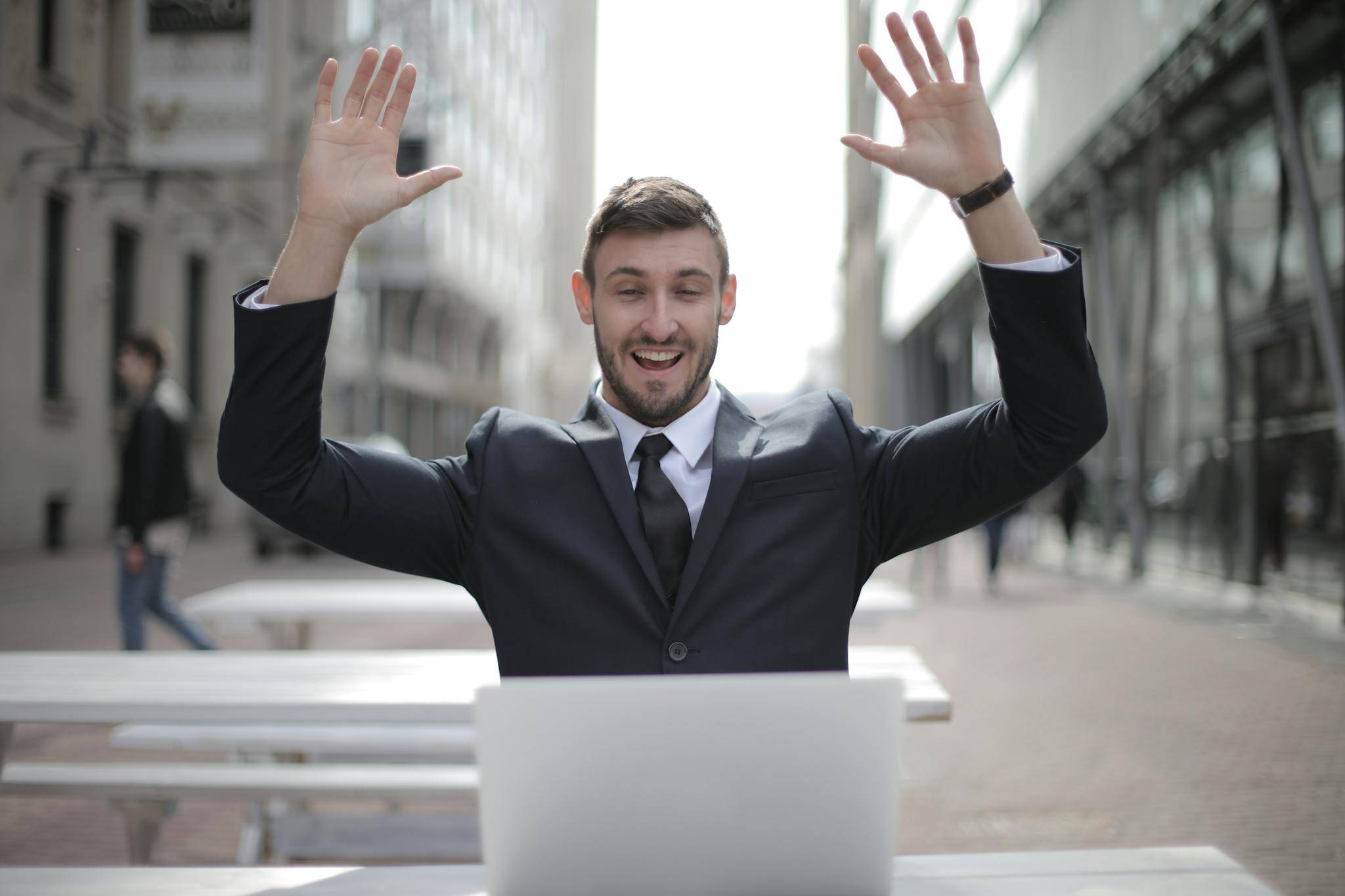 Man in Black Suit Raising Both Hands