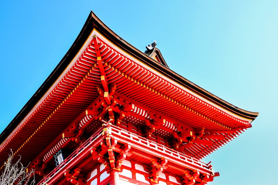 A red pagoda with a blue sky in the background