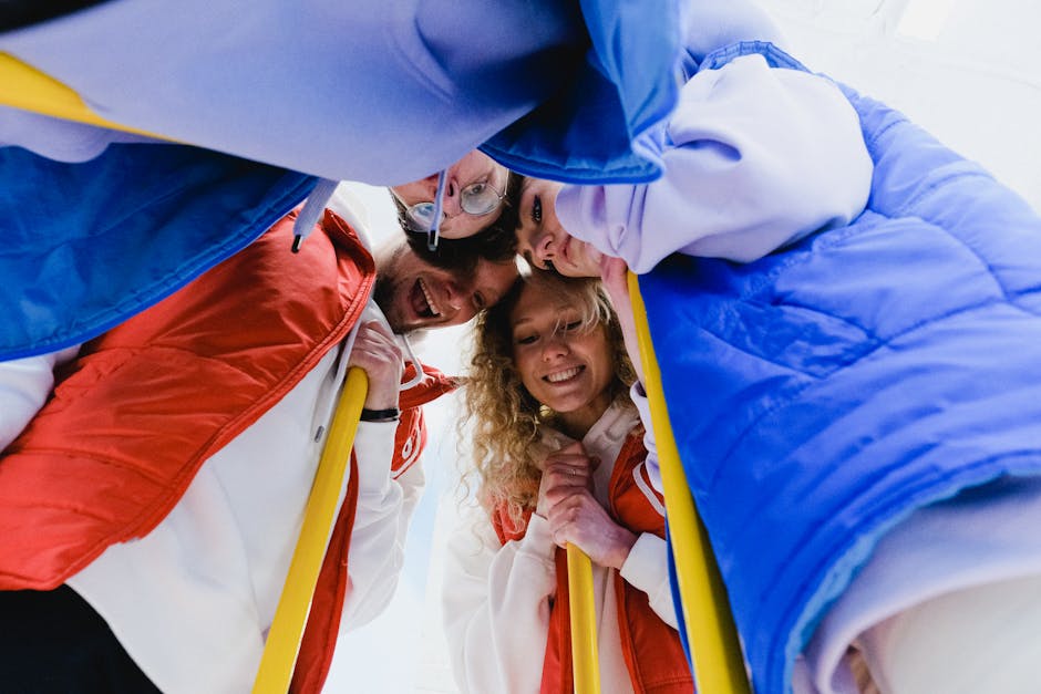 Low angle of cheerful curling team supporting each other in embrace during game