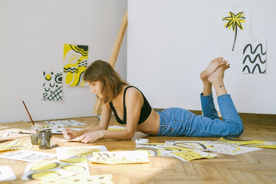 Photo of Woman Lying on Floor While Painting