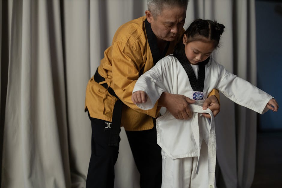 A Man in Yellow Gi Teaching Martial Arts