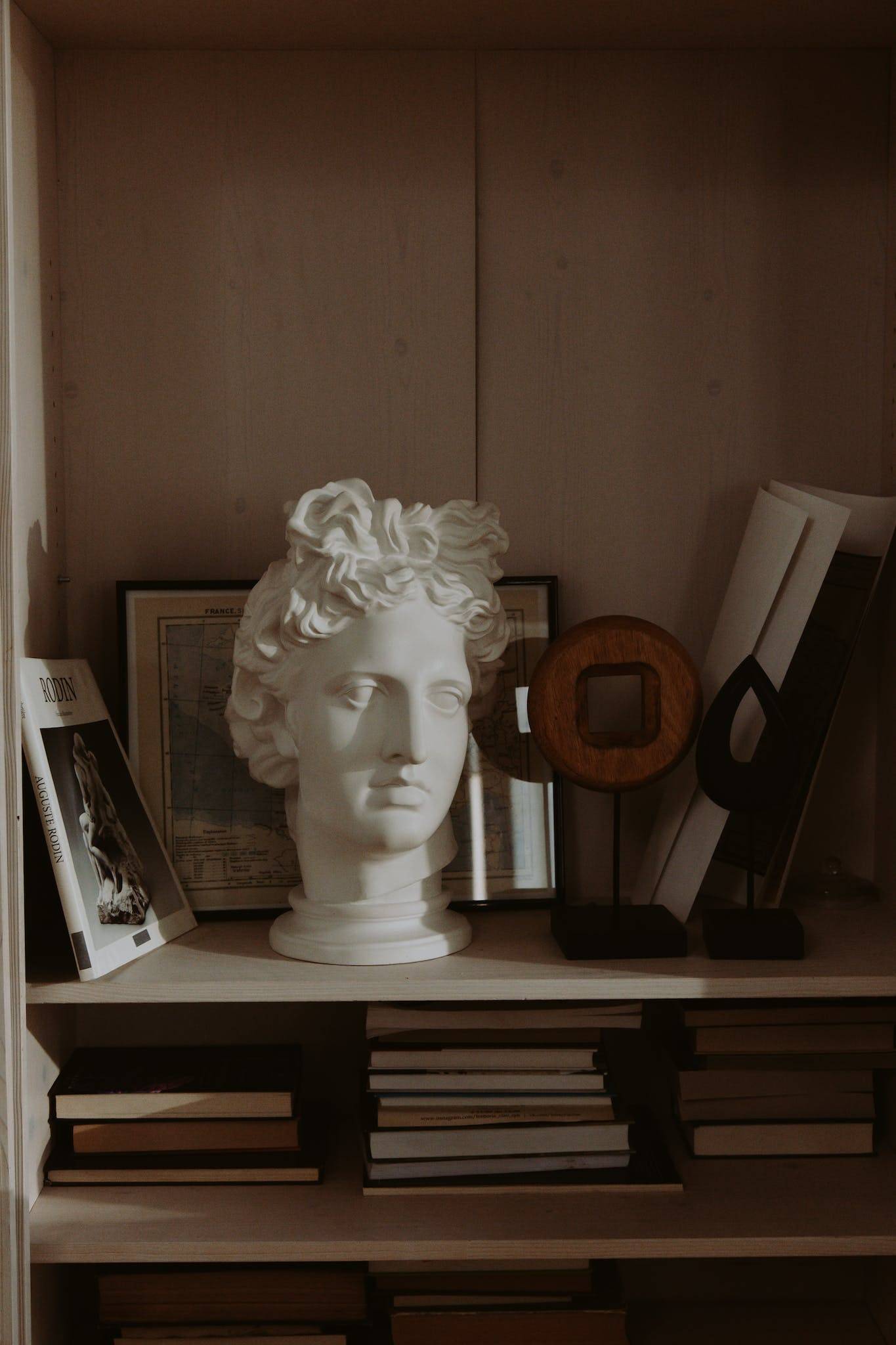 White Ceramic Head Bust on Black Wooden Table