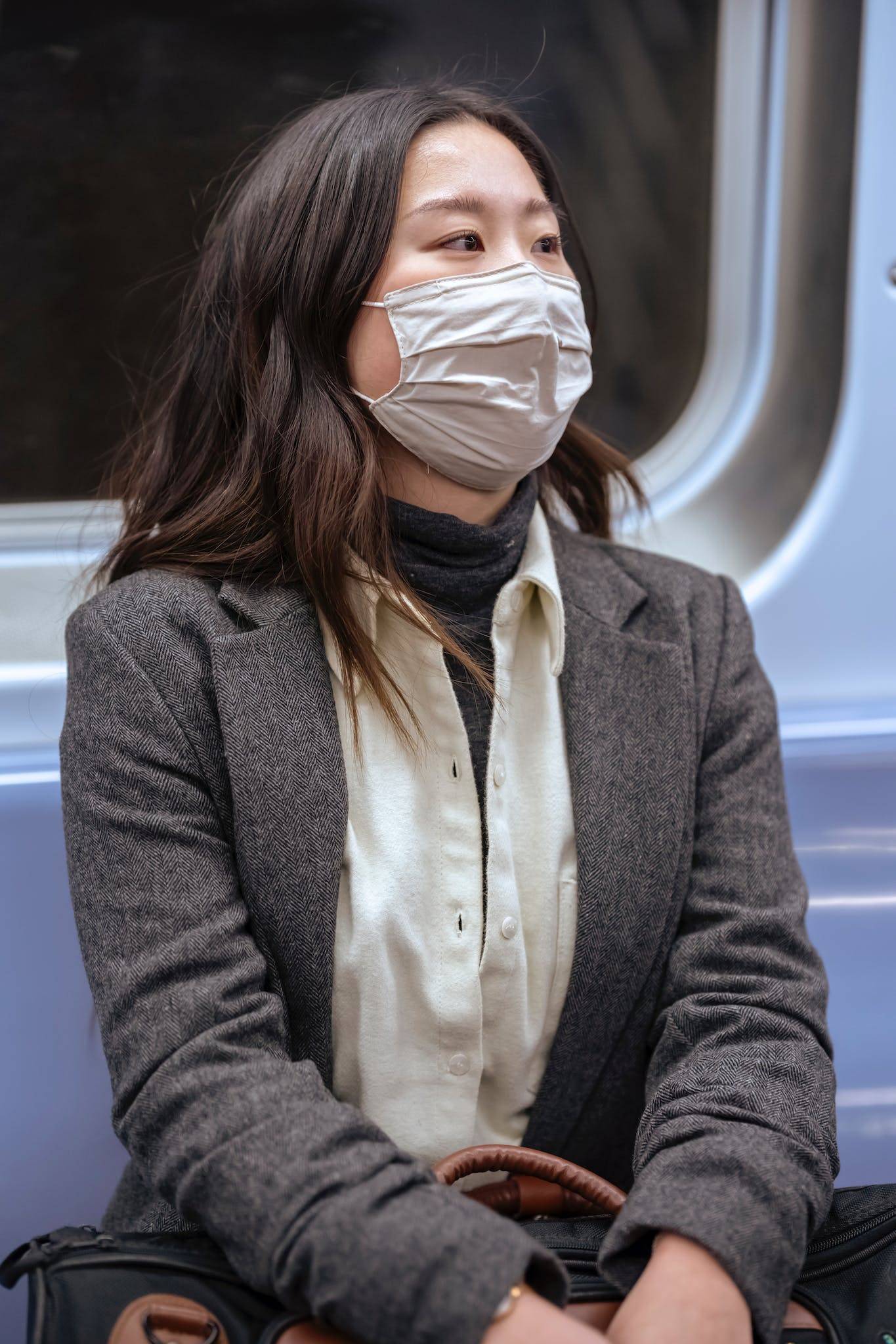 Young woman in medical mask in city