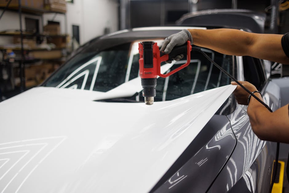 A Person Heating the Wrap of a Car