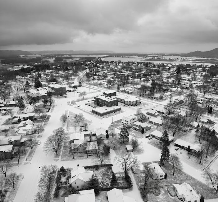 A black and white photo of a snowy town