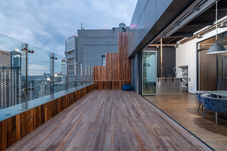 Empty spacious terrace with wooden floor and walls placed in modern apartment in cloudy day