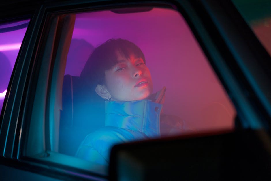 Woman Sitting in Car on Passenger Seat